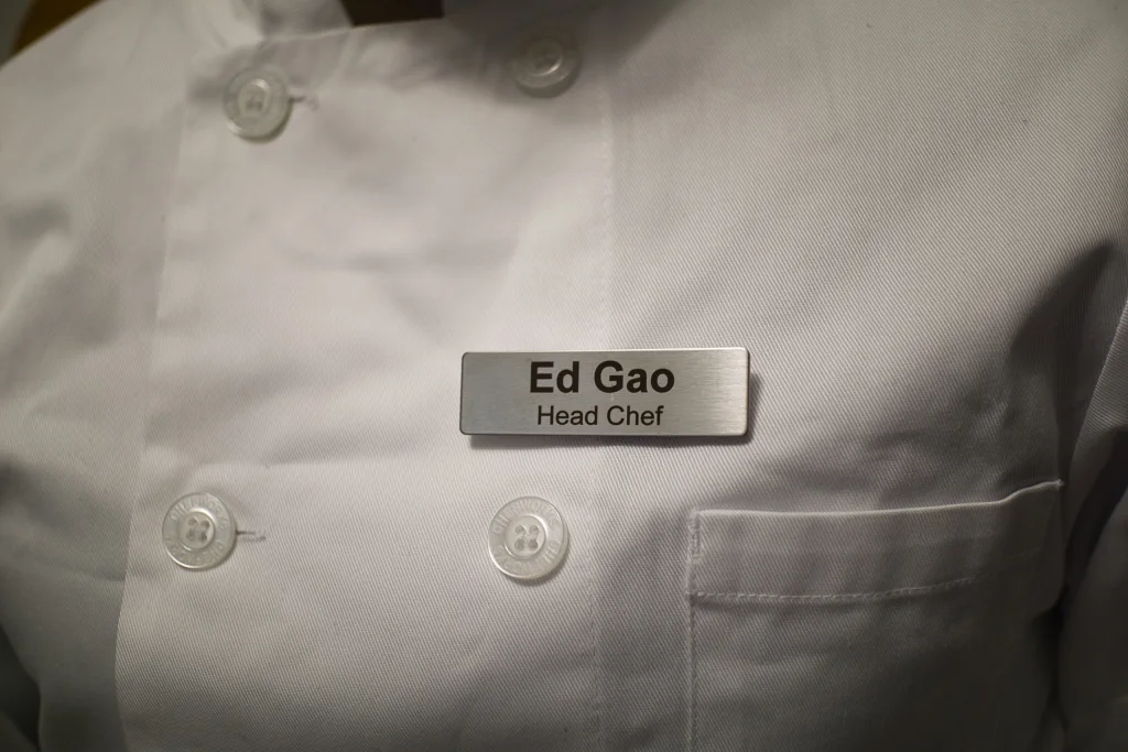 Ed Gao’s head chef badge on a white chef jacket