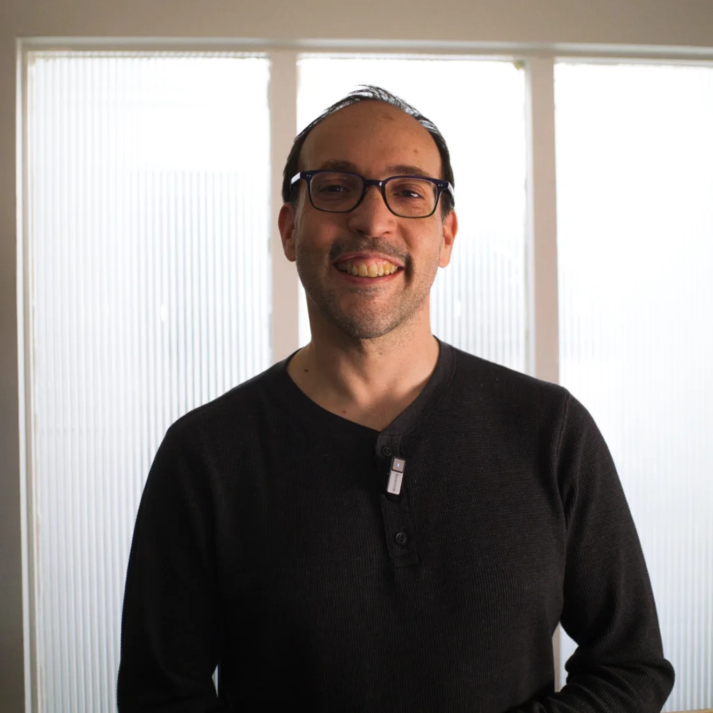 Felipe Hoffa smiling in front of a bright textured window before dinner